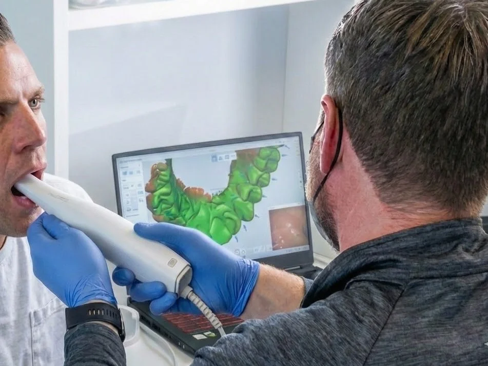 A dental professional scanning a patient with an intraoral scanner.