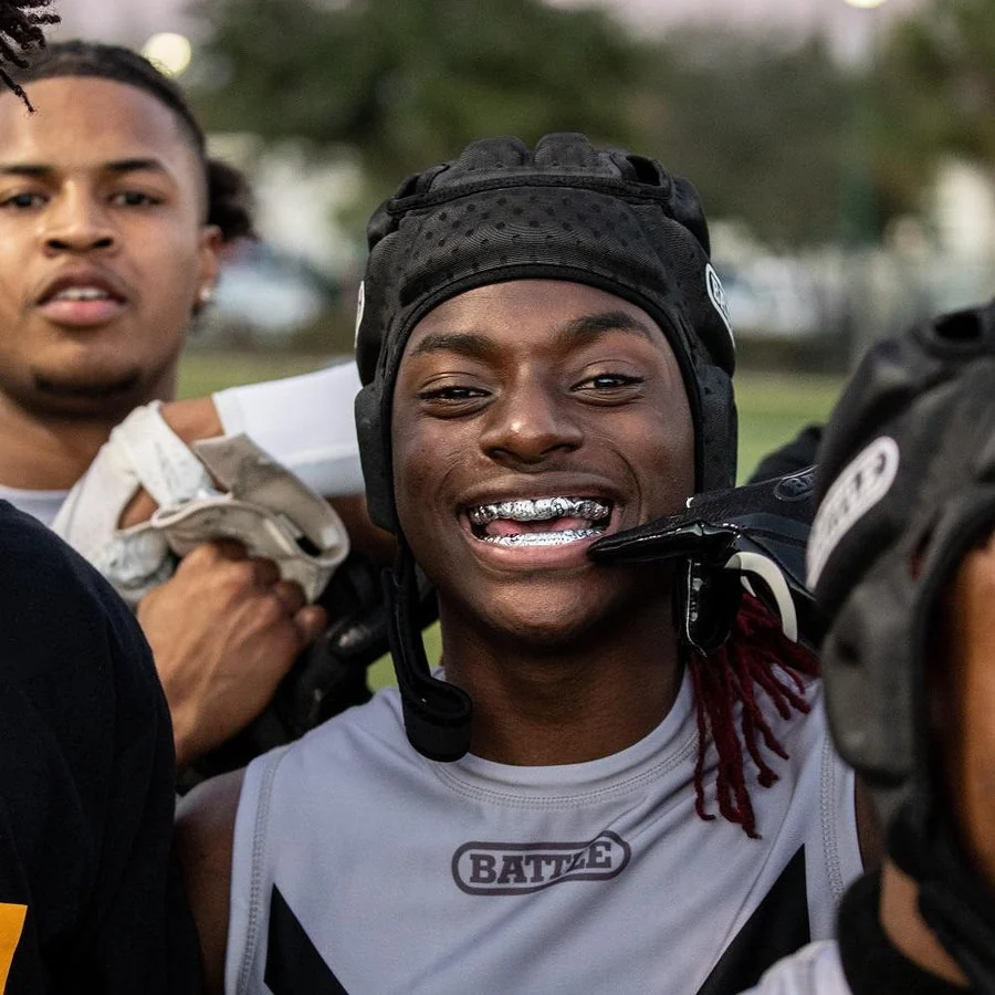Athlete wearing a visible sports mouthguard with teammates.