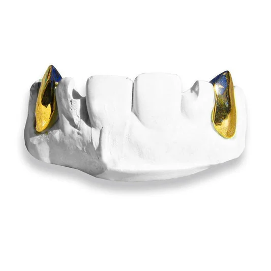 Gold fang accents on a dental model.